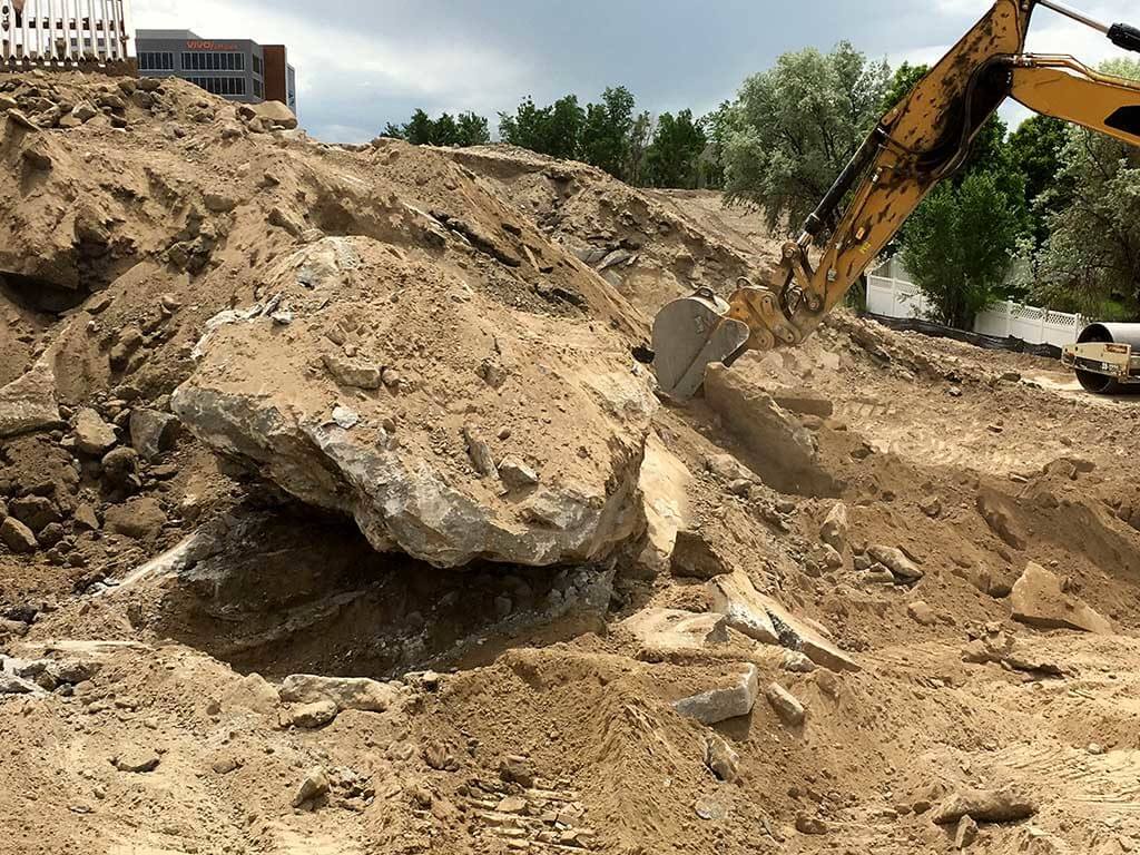 excavating giant concrete from old dump